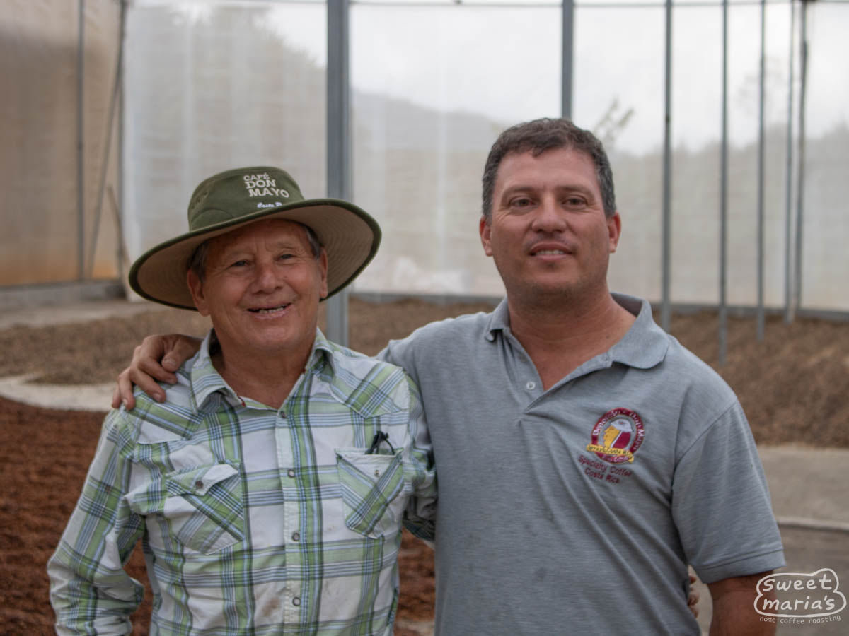 Hector (left) and Pablo (right) Bonilla pose for a "father/son" photo at their Don Mayo micromill in Tarrazu.