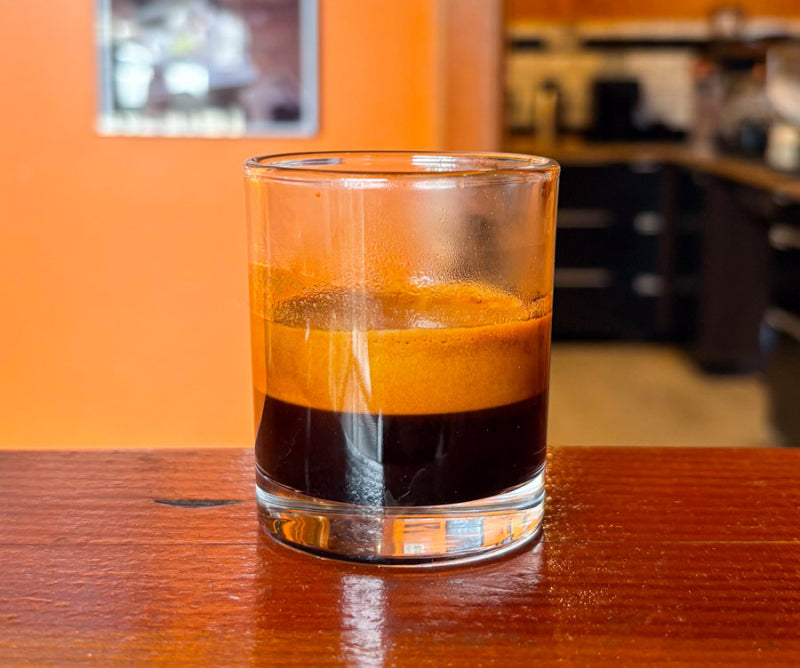 Glass of espresso with crema on a wooden table for the Silvertone coffee review