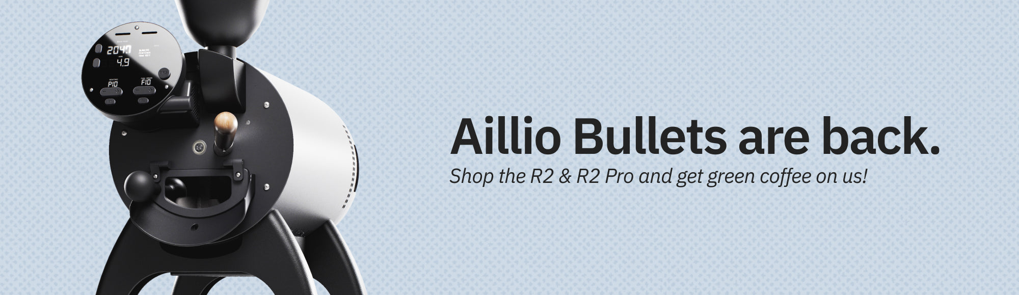 The Aillio Bullet R2 on a dotted light blue background. The caption reads: Aillio Bullets are back. Shop the R2 and R2 Pro and get green coffee on us.