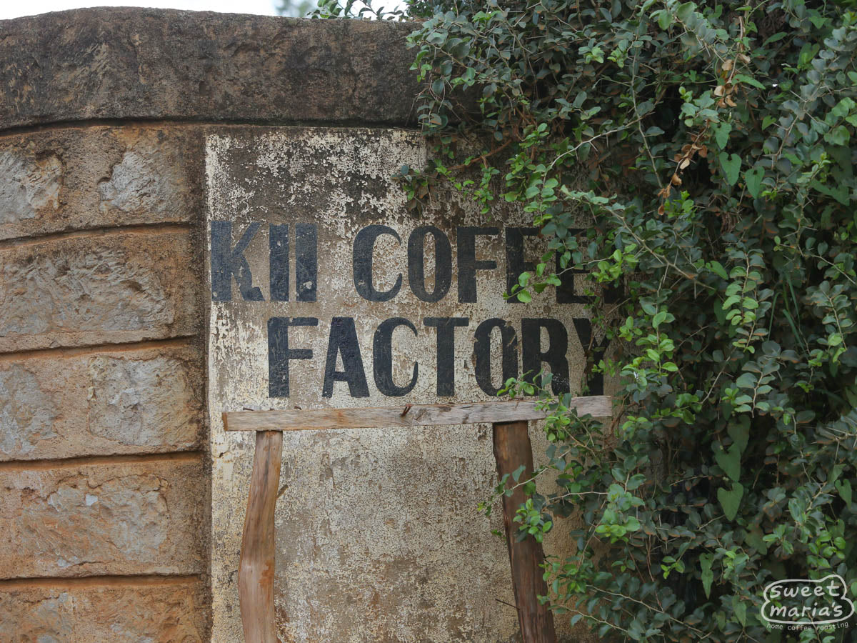 The hand-painted sign on the cement wall outside of the factory that reads, "Kii Coffee Factory", named after the Kii river that separates Kirinyaga from Embu. Kenya. We drove by it on a trip, but were not able to stop for a visit!